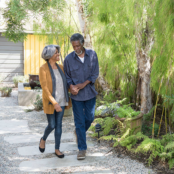 istock Senior African American couple walking on garden path 623700738
