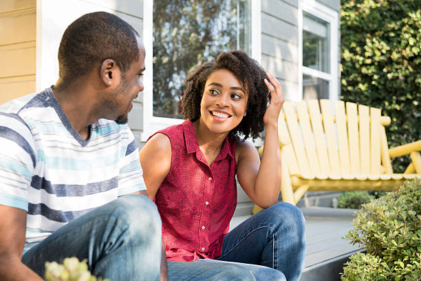 istock Young African American couple talking on porch step 623700924