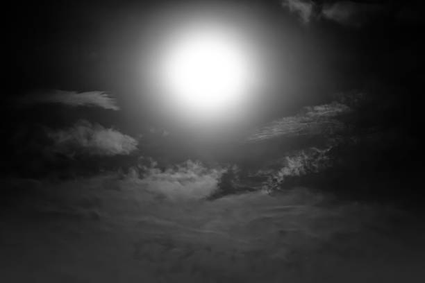 Background of nighttime sky with cloud and full moon with shiny. Natural beauty at night in black and white style. Vintage effect tone. The moon were NOT furnished by NASA.