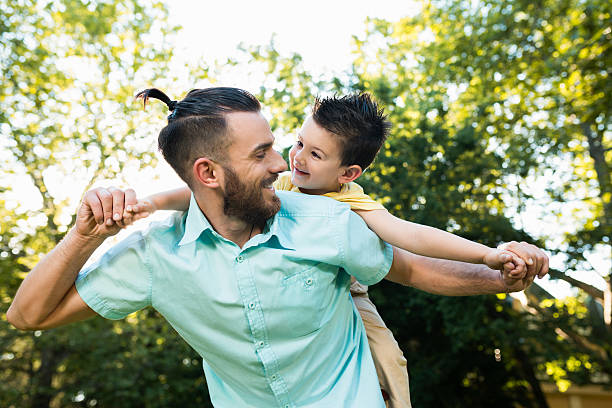 istock Smiling father giving his little son piggyback ride 623702736
