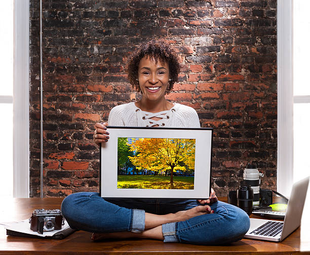 freelance photographer portrait Young african American woman freelance photographer portrait. cross legged photos stock pictures, royalty-free photos & images