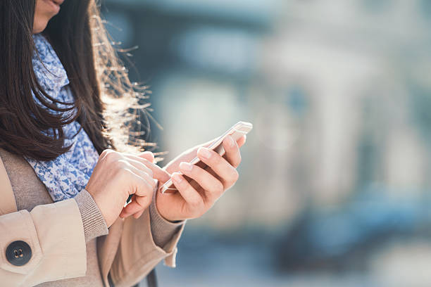 istock Young woman holding smart phone 623705108