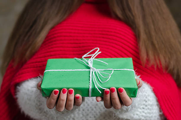istock girl with thick and long hair holding a gift 623705590