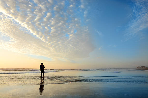 istock Man enjoying time  on beach at sunrise. 623707940