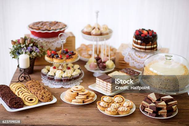 Table With Various Cookies Tarts Cakes Cupcakes And Cakepops Stock Photo - Download Image Now