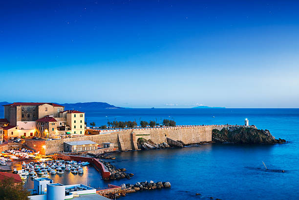 Piombino old town twilight panoramic view on piazza bovio lighth