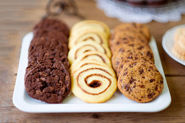 Table with various types of cookies on tray. Studio shot.