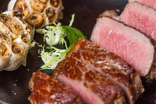 istock Sliced steak with roasted garlic and salt 623709534