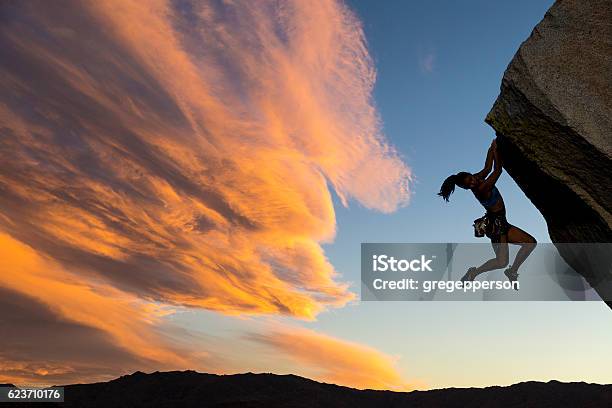 Rock Climber Clinging To A Cliff Stock Photo - Download Image Now - Rock Climbing, Climbing, Hanging