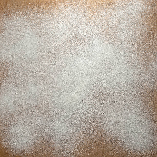 Sprinkled Icing Sugar Icing sugar on a wooden board background. sprinkling powdered sugar stock pictures, royalty-free photos & images