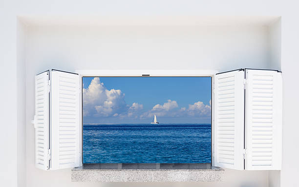 istock window with shutters overlooking the sea 623713254