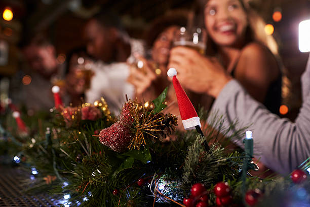 christmas party at a bar, focus on foreground decorations - christmas people stockfoto's en -beelden