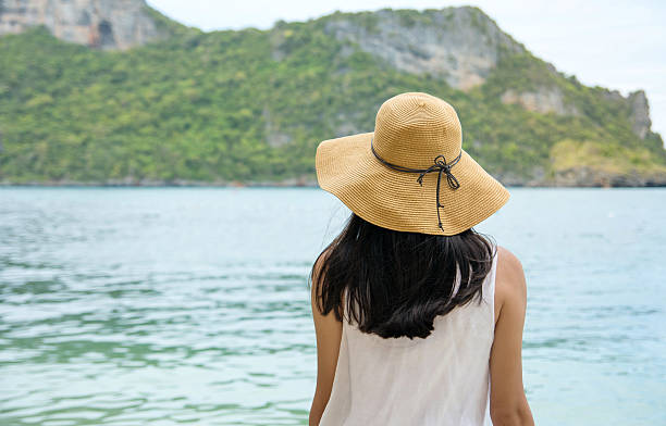istock Woman looking  towards the sea water 623716256