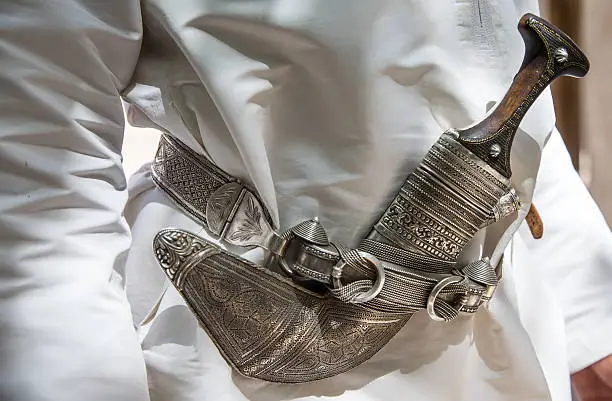 omani dagger or 'khanjah' worn on a belt of traditional omani