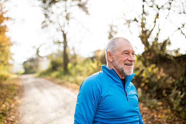 istock Senior runner smiling and resting in sunny summer nature. 623741334