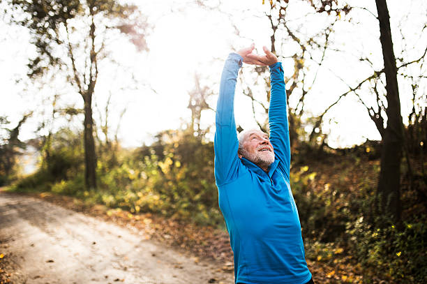 istock Senior runner doing stretching in sunny autumn nature. 623741548