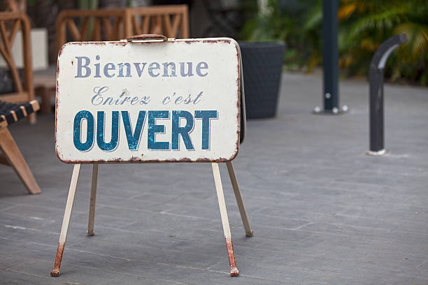 French outdoor Open sign Metallic outdoor shop sign stating in french “Bienvenue, Entrez, c'est OUVERT”, meaning in english “Welcome, Enter, it's OPEN”. french language photos stock pictures, royalty-free photos & images