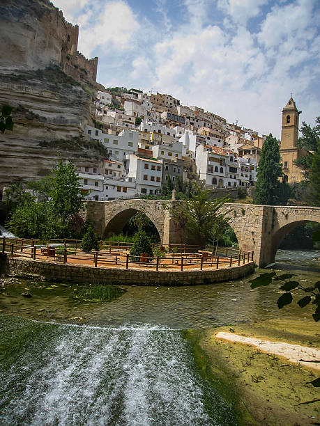 Cityscape with bridge over river at Alcala del Jucar in Castilla la Mancha, Spain
