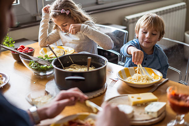 istock Kids eating pasta for lunch 623746230