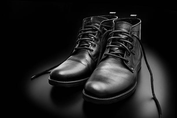 istock Men's black boots on black background 623747214