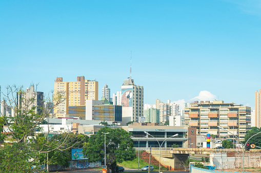Campo Grande, Ms, Brazil - November 10, 2016: Landscape of the city of Campo Grande. City with some buildings between trees, car traffic and urban art.