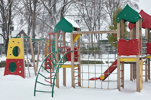 istock Children playground in winter snow covered snowfall 623749468