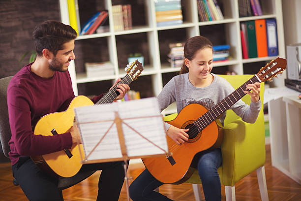 istock Guitar teacher teaching the little girl 623750896
