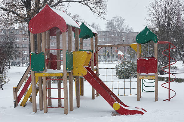 istock Children playground in winter snow covered snowfall 623751138
