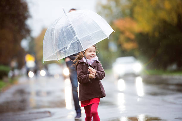 istock Father with little daughter under umbrella. Walk on rainy day. 623753042