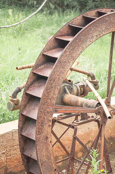 istock Not working old rusty water wheel abandoned to time. 623754726