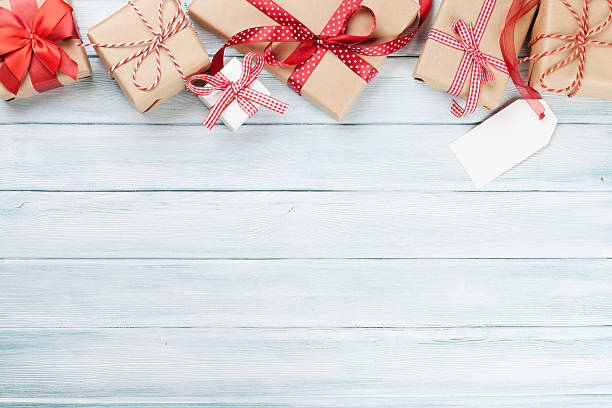 istock Christmas wooden background with gift boxes 623756082