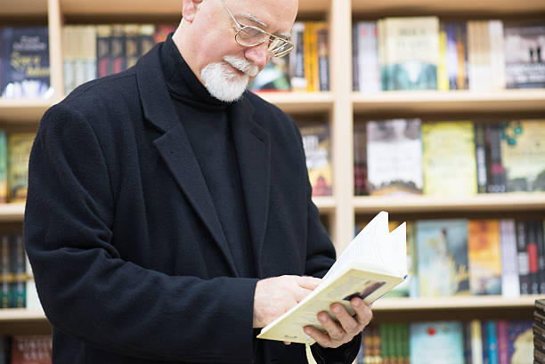 istock Man is selecting the book from bookshelf in a library 623758528