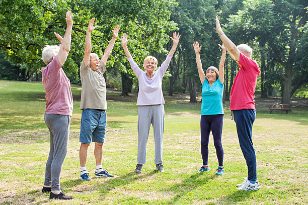 istock Smiling seniors exercising outside in the park 623761482