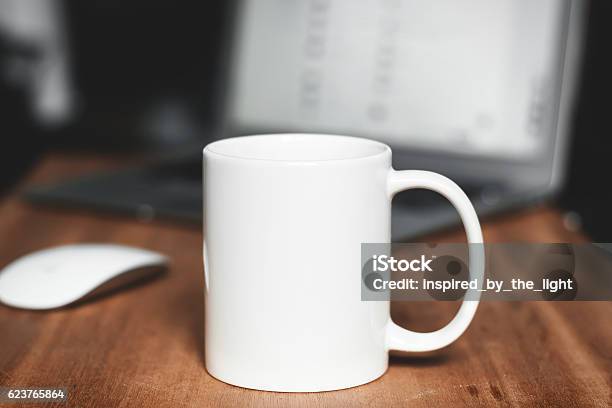 White Mug On The Desktop Stock Photo - Download Image Now - Mug, Office, White Color