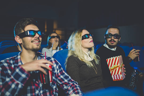 istock Friends laughing while watching a movie 623769464