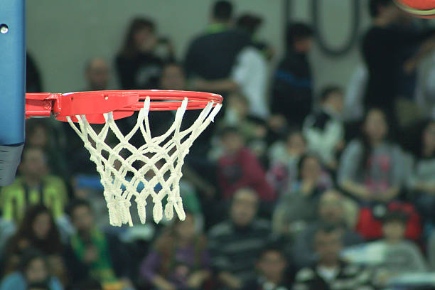 istock basketball while enters in the basket during basketball game 623770450