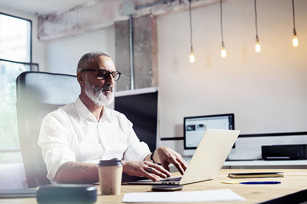 istock Middle age financial analyst wearing a classic glasses and working 623773100
