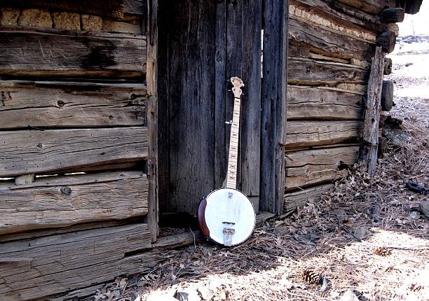 Banjo and Old Cabin Banjos and old cabins go together well for bluegrass and blues music. This is a picture of my banjo at an old mining cabin up in the banjo stock pictures, royalty-free photos & images