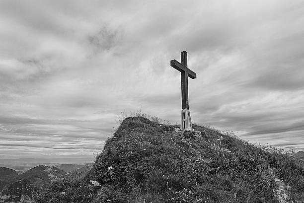 istock Black and white image of a cross on hillside in 623776104