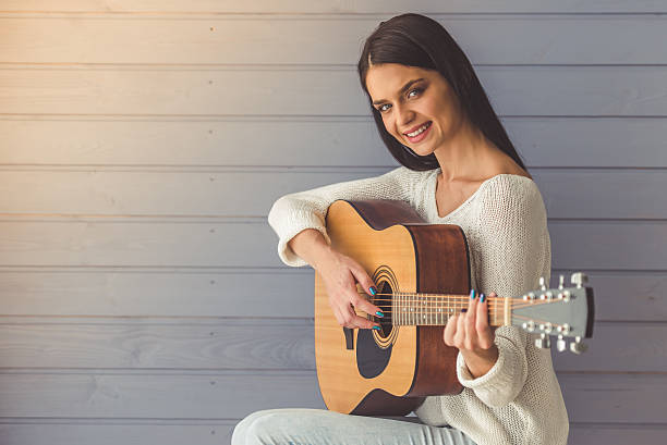 istock Attractive girl playing guitar 623776362