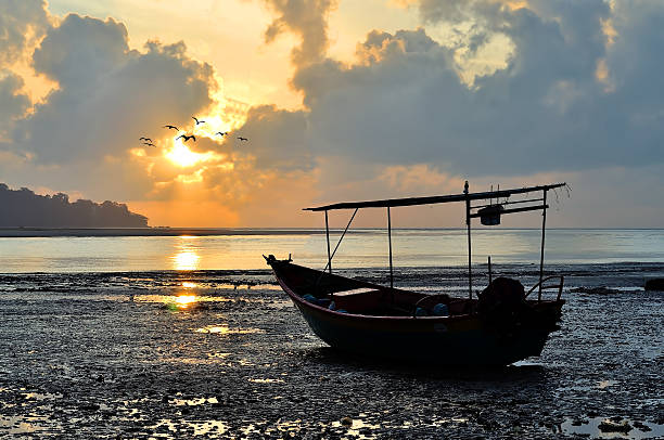 istock Fishing boat on the beach when sun rising up 623776470