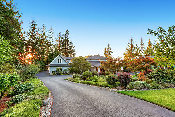 istock Custom built luxury house with long concrete driveway. 623776784