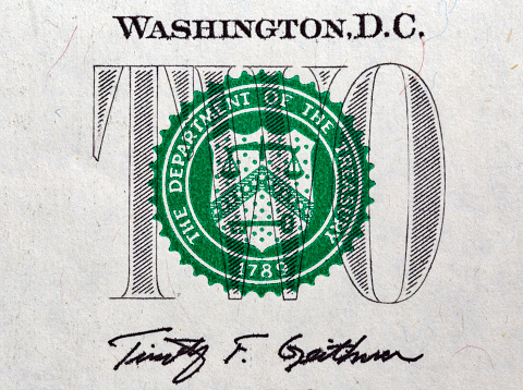 Stamp of the Department of The Treasury on US two dollar bill closeup macro