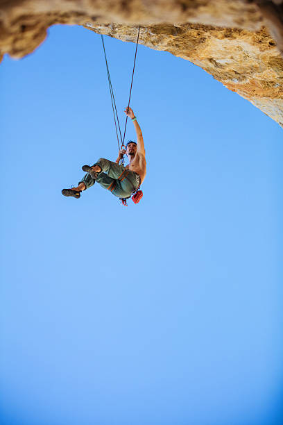 istock Male rock climber hanging on rope 623778258