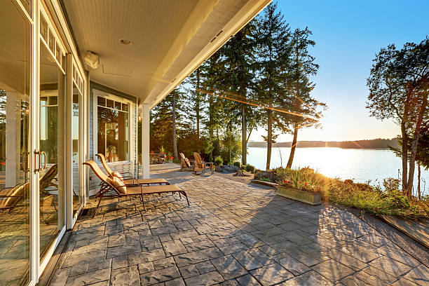 istock Large stone floor patio area of waterfront house 623778266
