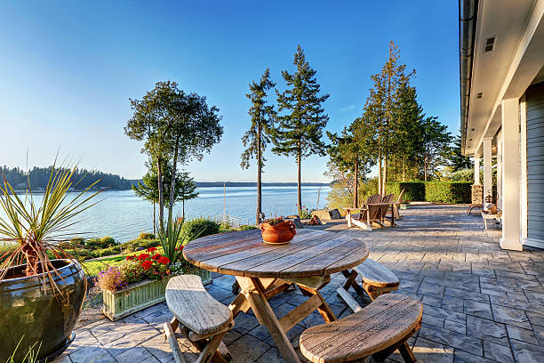 istock Large stone floor patio area of waterfront house 623779338