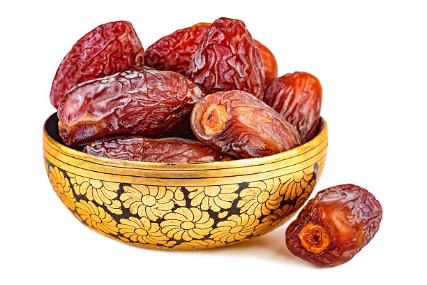 istock sweet dried dates in oriental cup isolated on white 623779666