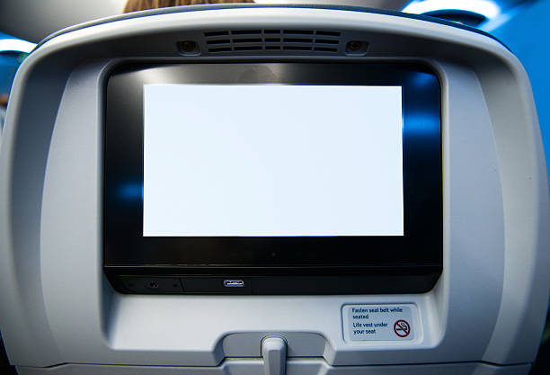 Movie Screen on Passenger Seat of Airplane stock photo