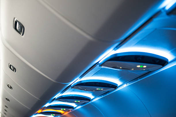 Overhead Luggage Compartment and Call Light Inside Airplane Cabin stock photo