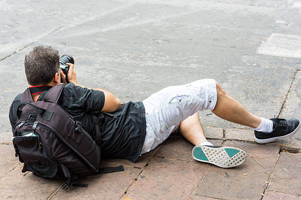 istock Photographer shooting lying on the floor 623782582